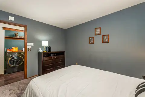 Bedroom with a bed and view into a laundry area, Grand Regency Retreat