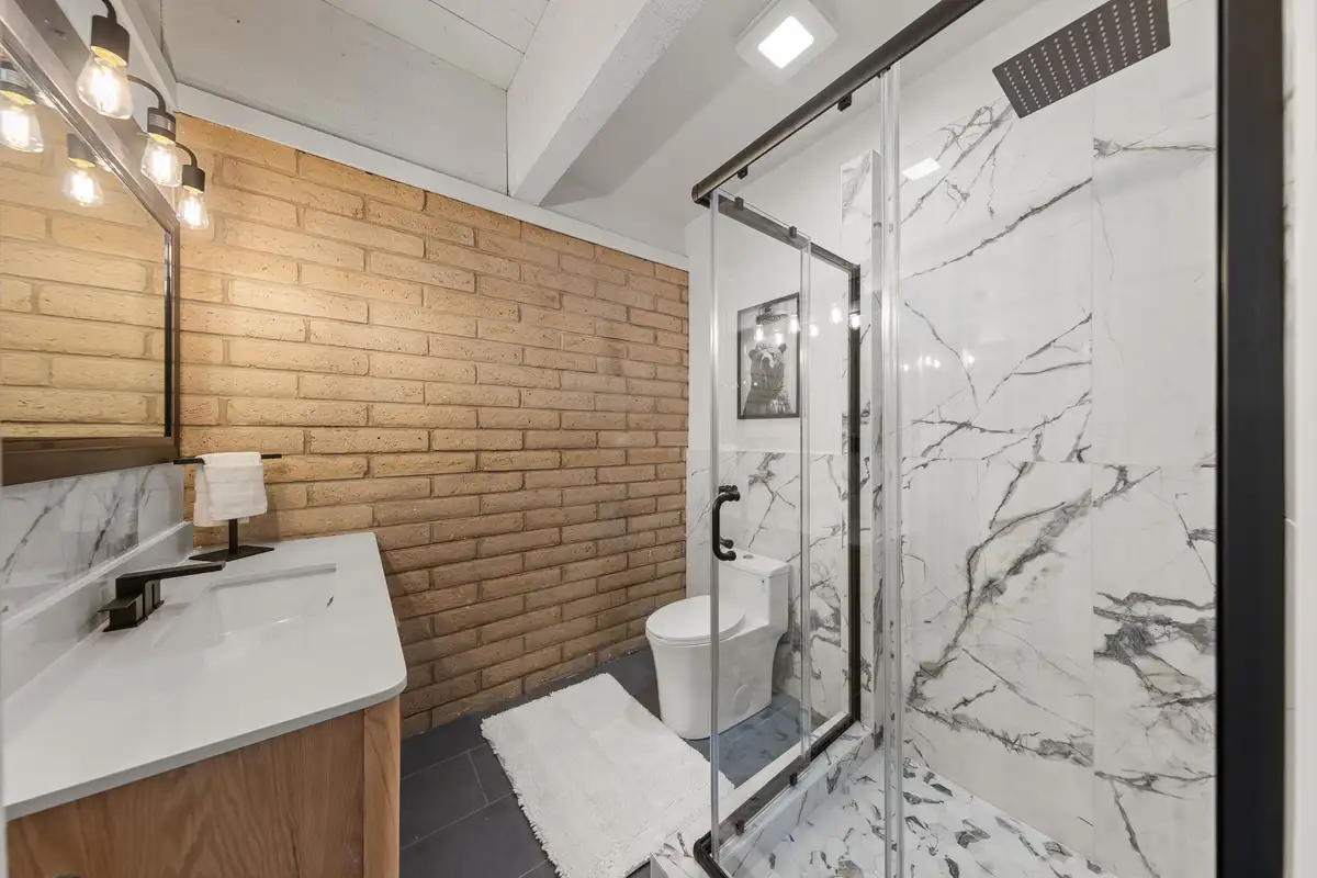 Upstairs bathroom with glass-enclosed marble walk-in shower, Treetop on Country Club