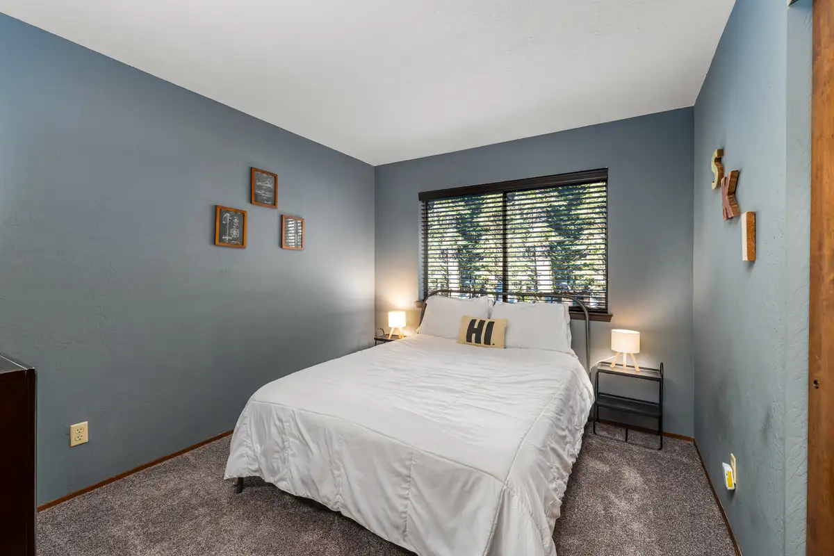 Bedroom with a bed and blue-gray walls, Grand Regency Retreat