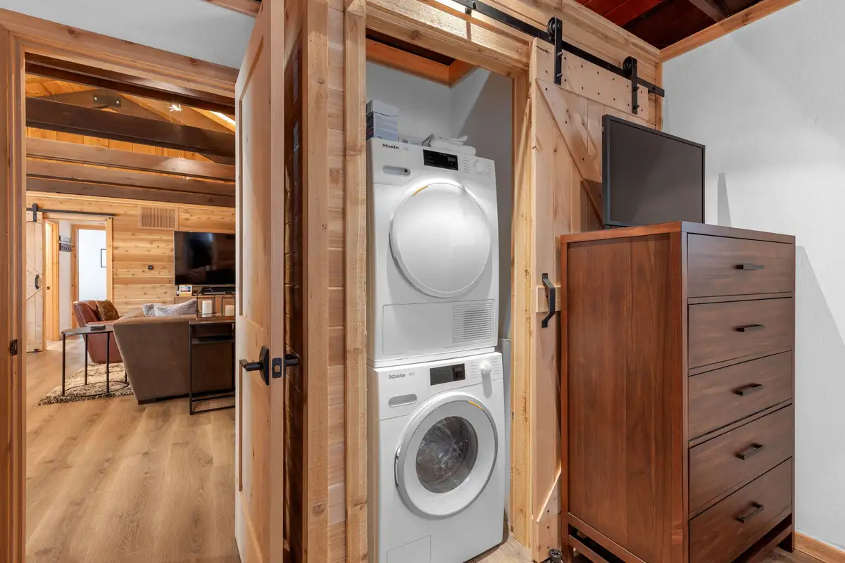 Stacked washer and dryer behind a barn door, Updated West Shore Cabin 1 mile to Chambers Beach
