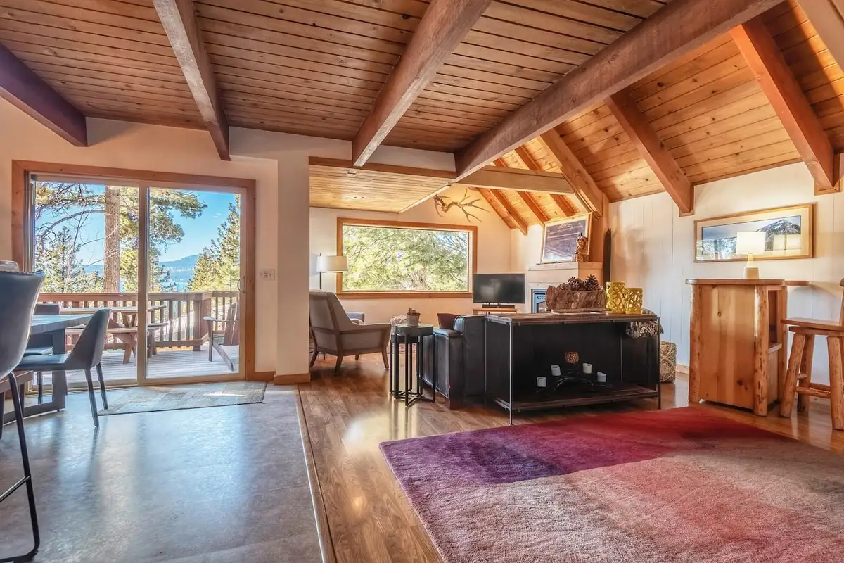Living area with beamed ceiling and sliding doors to a deck, Lakeview Serenity Cottage