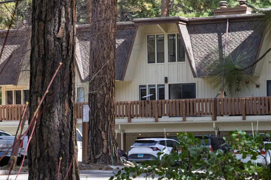 Charming A-frame exterior nestled among towering pine trees, Treetop on Country Club