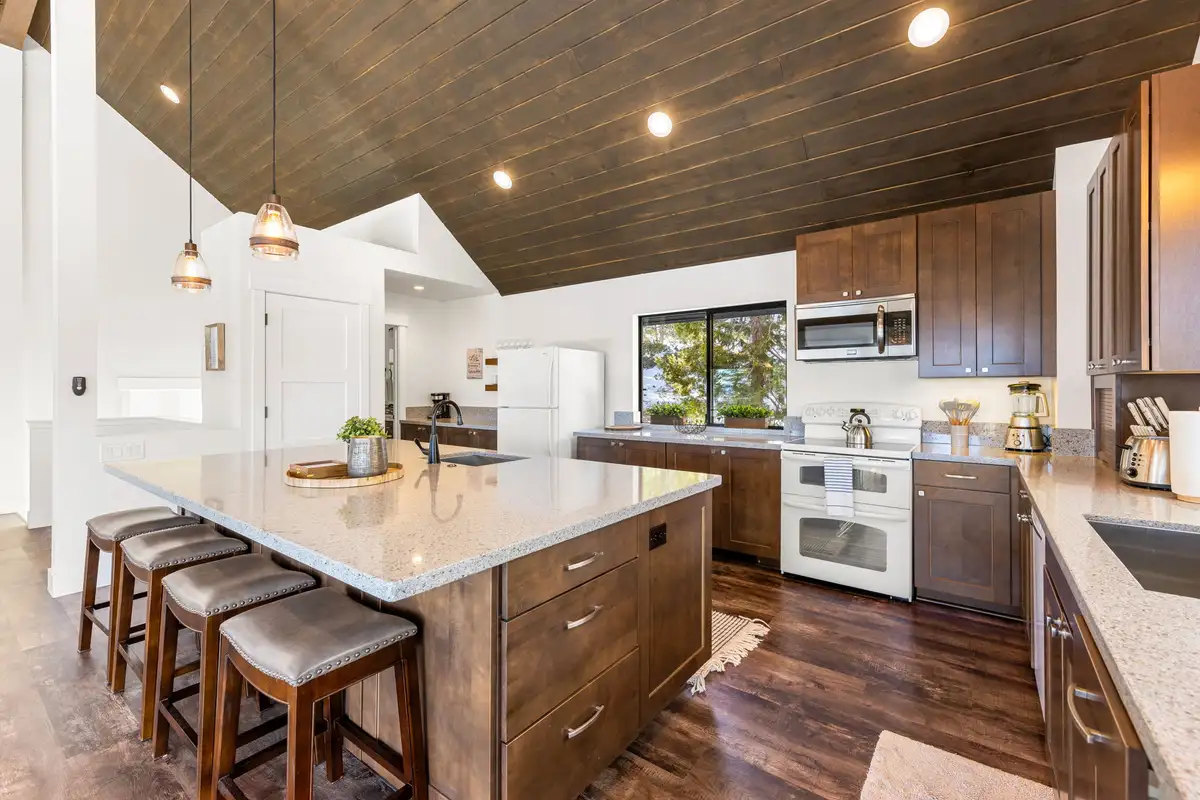 Kitchen with large island, bar stools and wood ceiling, Incline Lakehouse Lookout