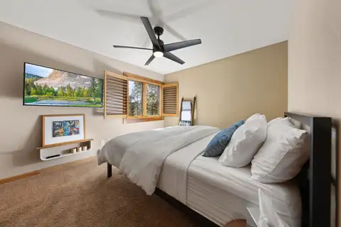 Bedroom with a bed, ceiling fan and wall TV, Elevated Tahoe Escape
