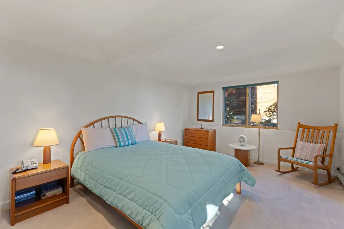 Bedroom with a bed and a rocking chair, 90s Tahoe Time Capsule