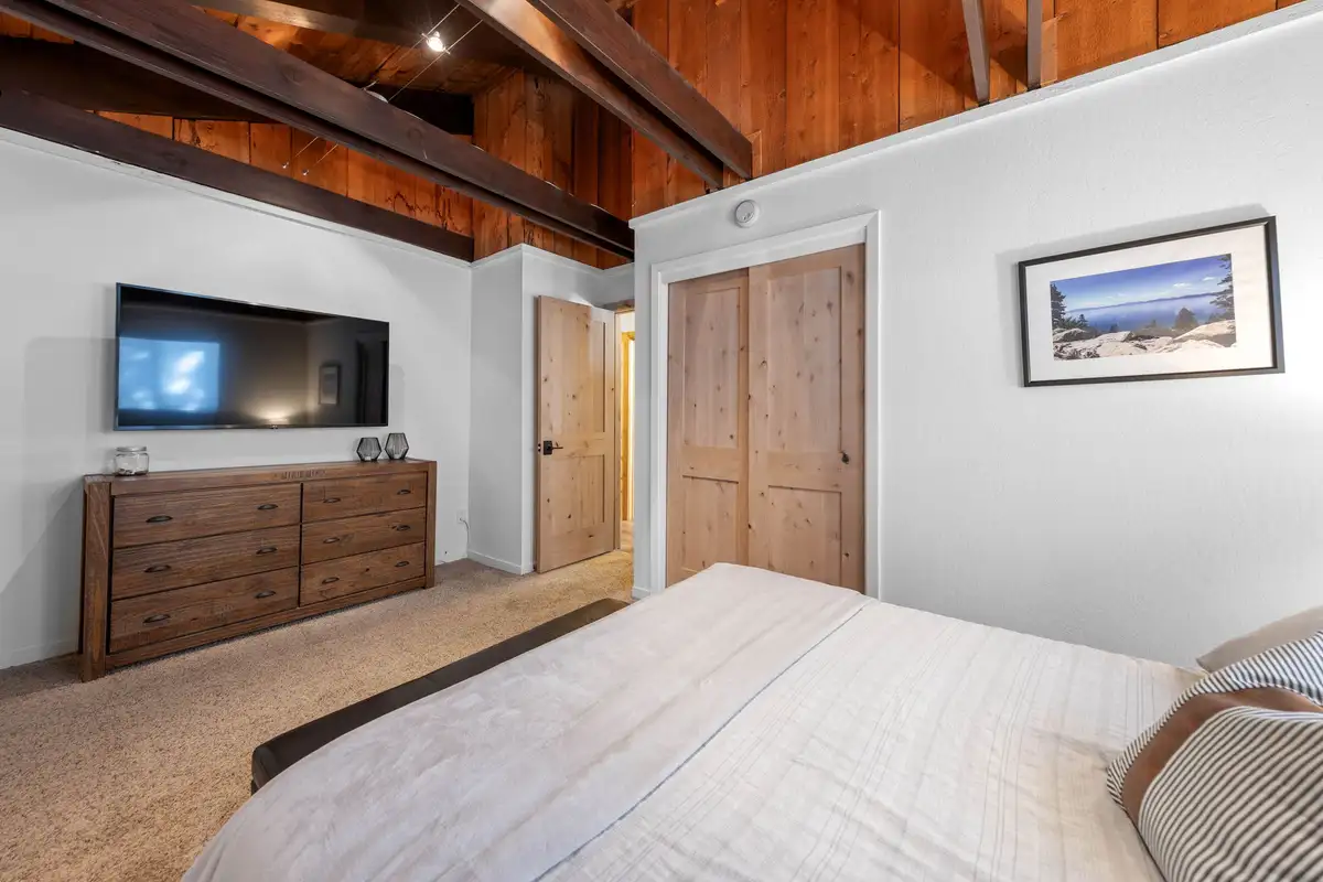 Bedroom with dresser and wall-mounted TV, Updated West Shore Cabin 1 mile to Chambers Beach