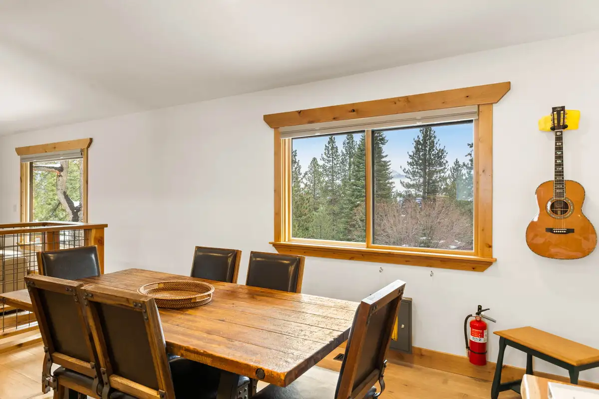 Dining table by a window with a guitar on the wall, Sugar Pine Tahoe Lodge