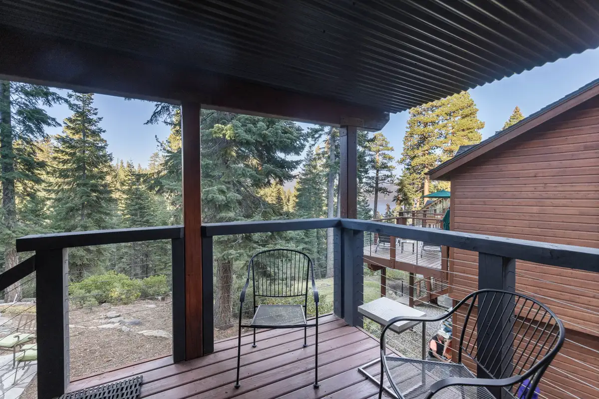 Covered balcony with chairs overlooking pines, Lakeview Grandeur