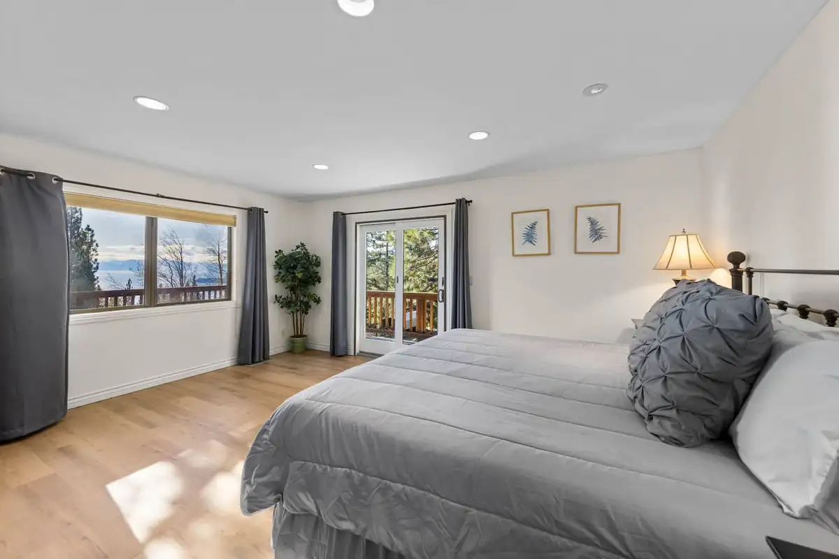 Bedroom with gray bedding and a door to a deck, Tranquil Alpine Bliss