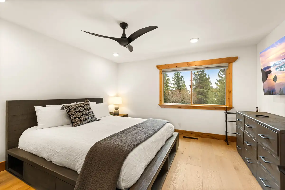 Bedroom with a bed, dresser and ceiling fan, Sugar Pine Tahoe Lodge