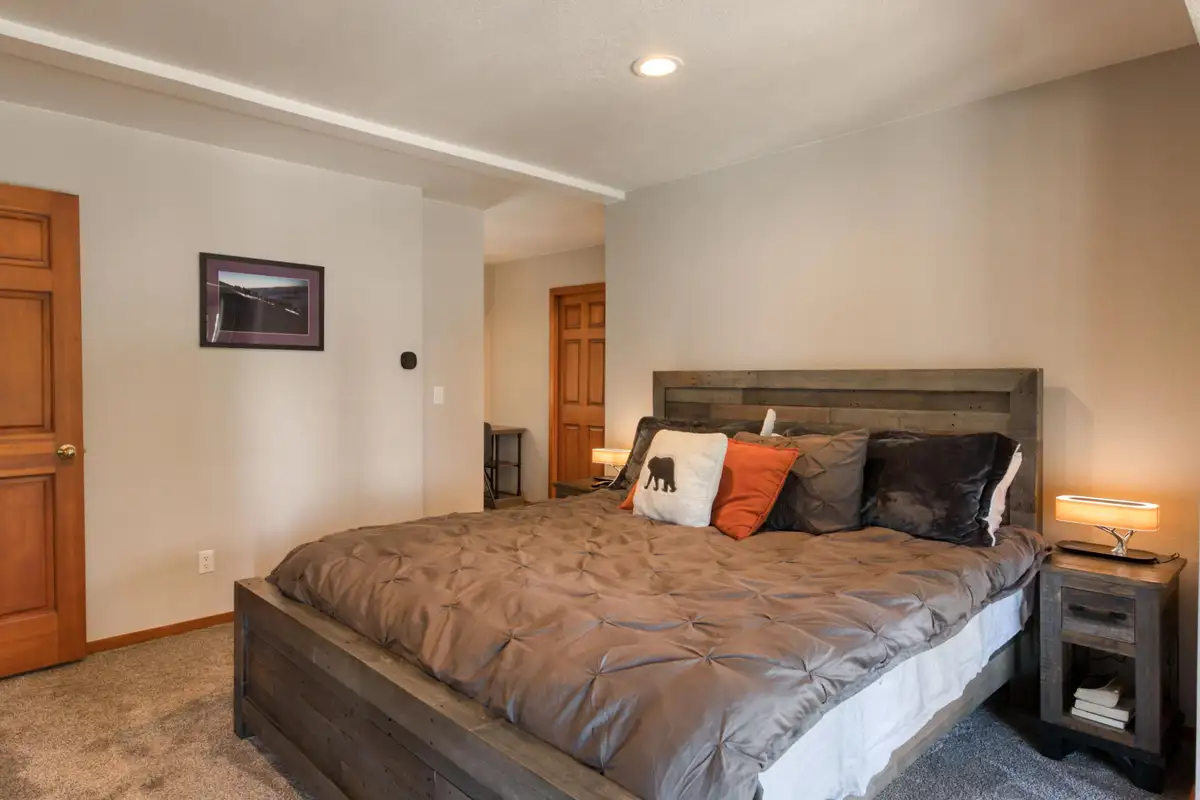 Bedroom with a bed and gray wood headboard, Lunar Lakeview Haven