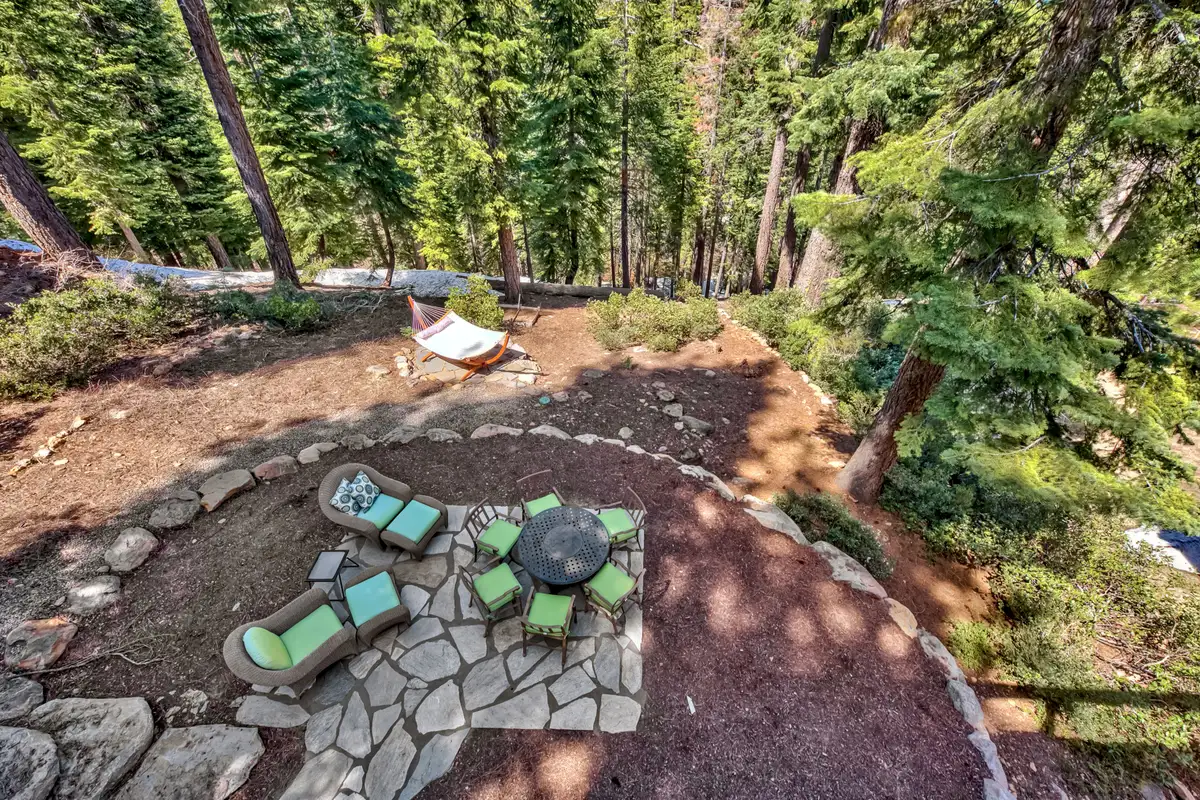 Aerial view of a stone fire pit area with chairs, Lakeview Grandeur