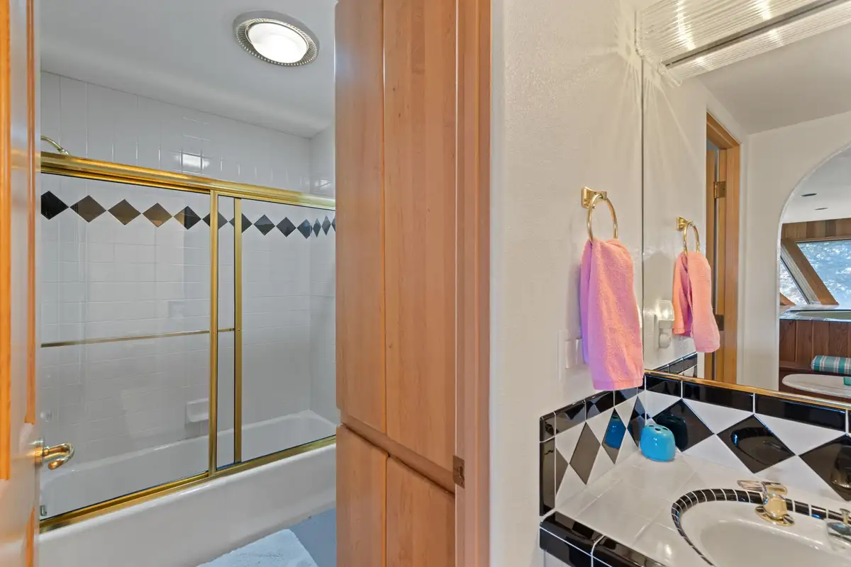 Bathroom with tub shower and diamond tile accents, 90s Tahoe Time Capsule