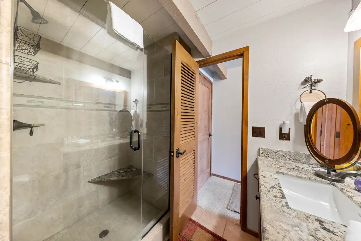 Bathroom with glass shower and granite vanity, Livin' on the Edge