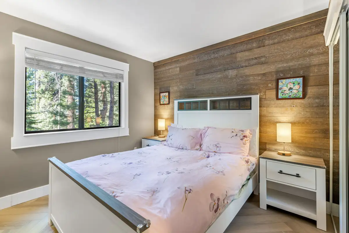 Bedroom with a white bed and wood-paneled accent wall, Tranquil Stay