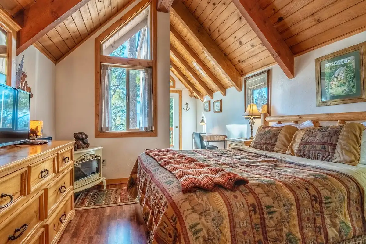 Bedroom with wood ceiling and electric stove heater, Lakeview Serenity Cottage