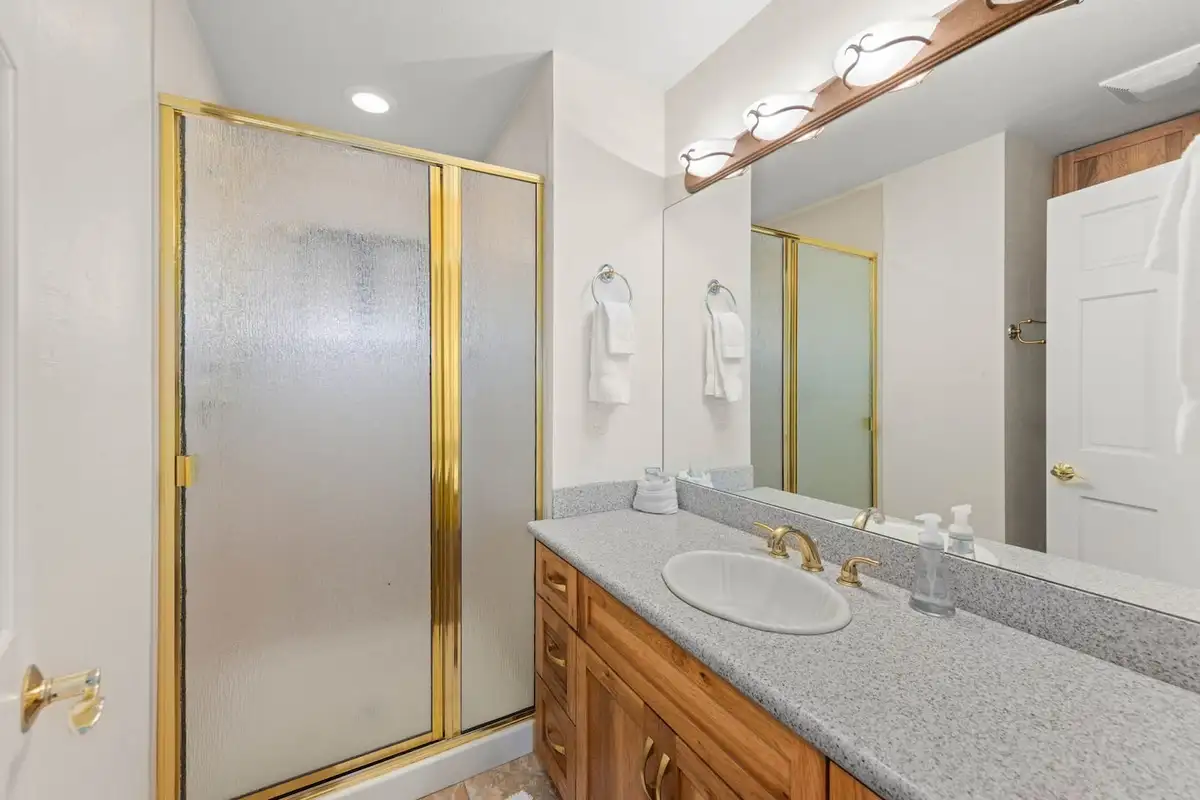 Bathroom with a glass shower and wood vanity, Tranquil Alpine Bliss