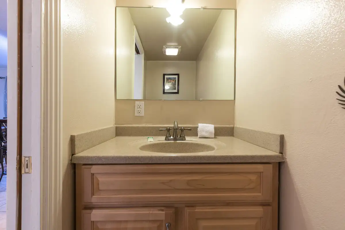 Bathroom vanity with a mirror and wood cabinet, Trailside Tahoe Townhouse