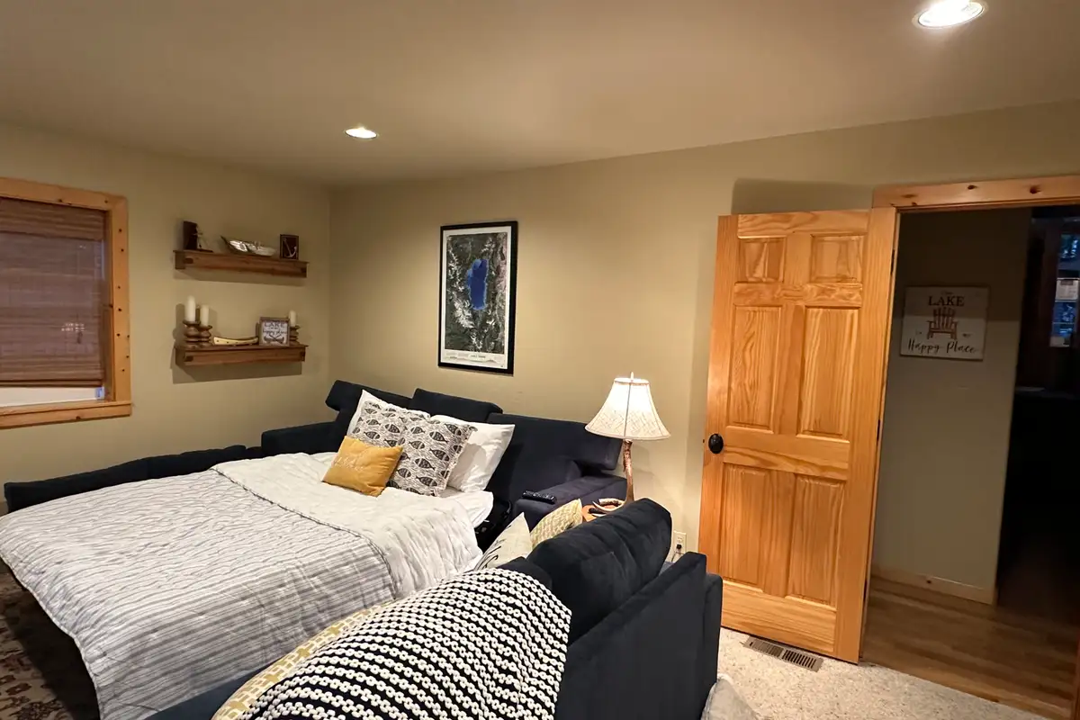 Room with a bed, loveseat and wood door, Lakeview Grandeur