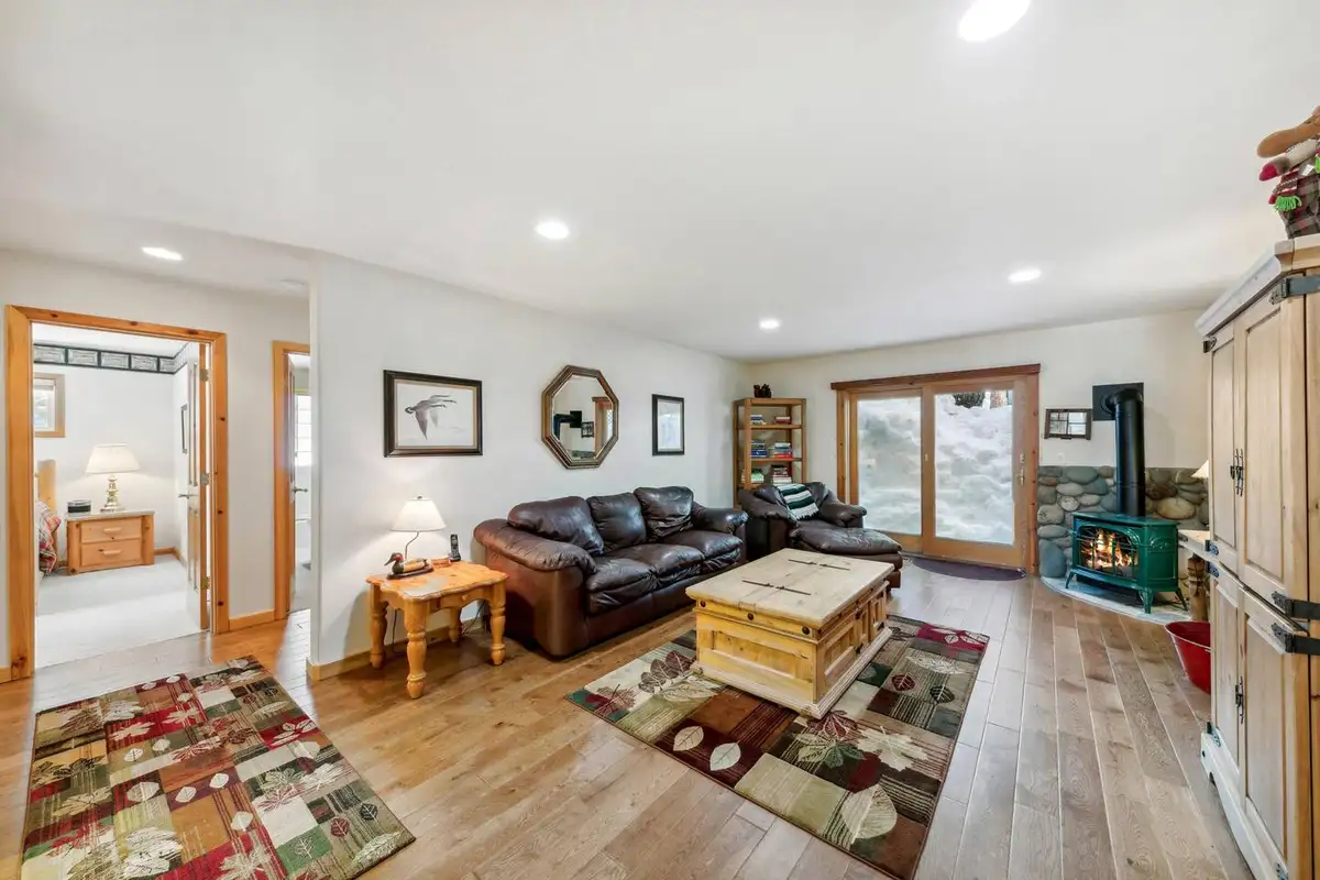 Den with leather sofa and wood stove, Hastings Hideaway Cabin