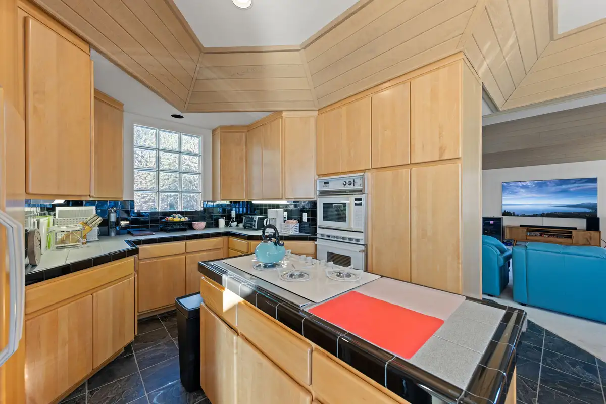 Kitchen with wood cabinets and tiled island, 90s Tahoe Time Capsule