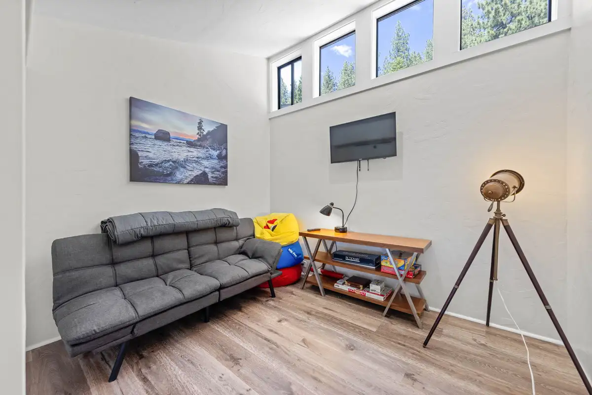 Den with a futon sofa and tripod floor lamp, Lakeview Haven in Incline Village