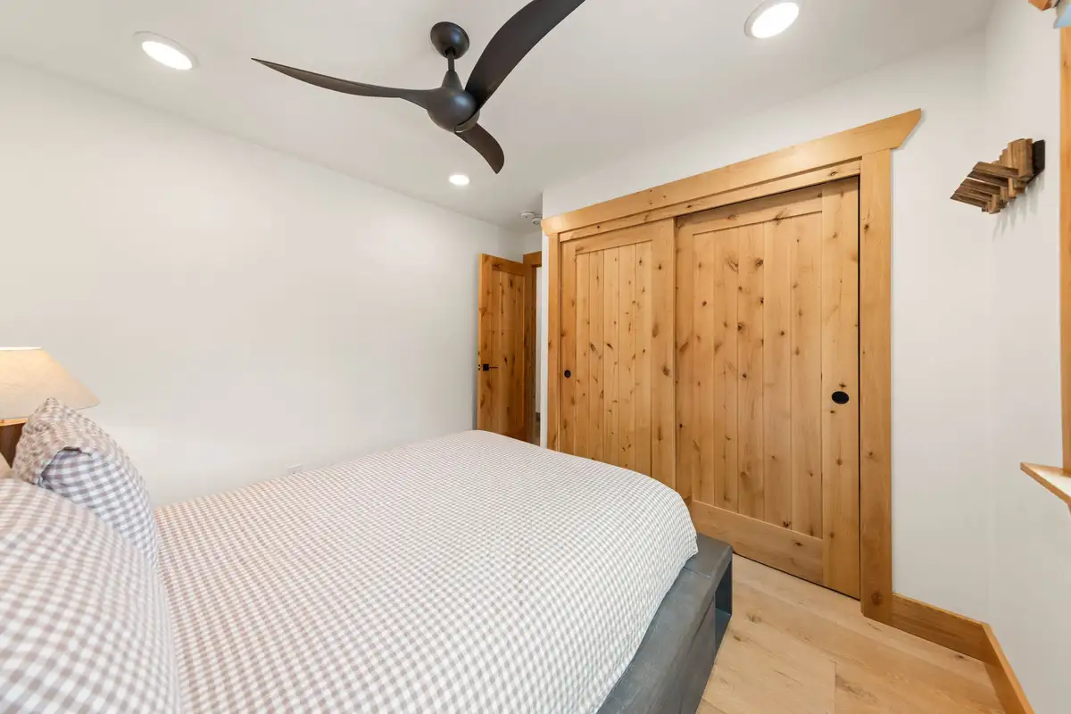 Bedroom with a bed and wood sliding closet doors, Sugar Pine Tahoe Lodge