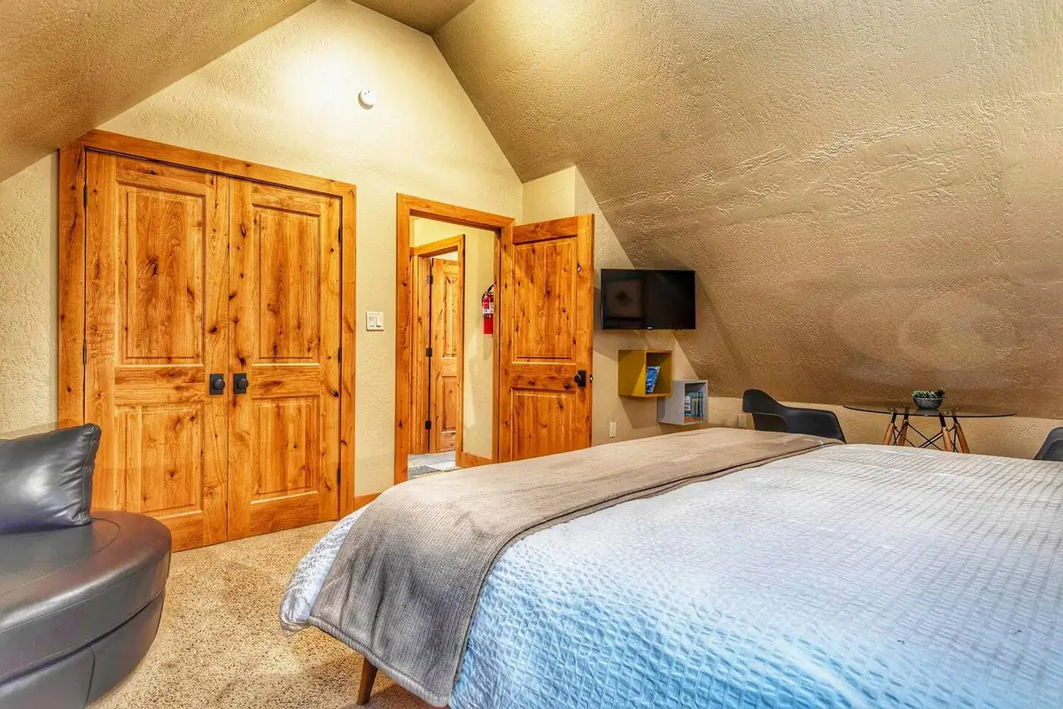 Bedroom with a bed and wooden double closet doors, Restful North Ridge