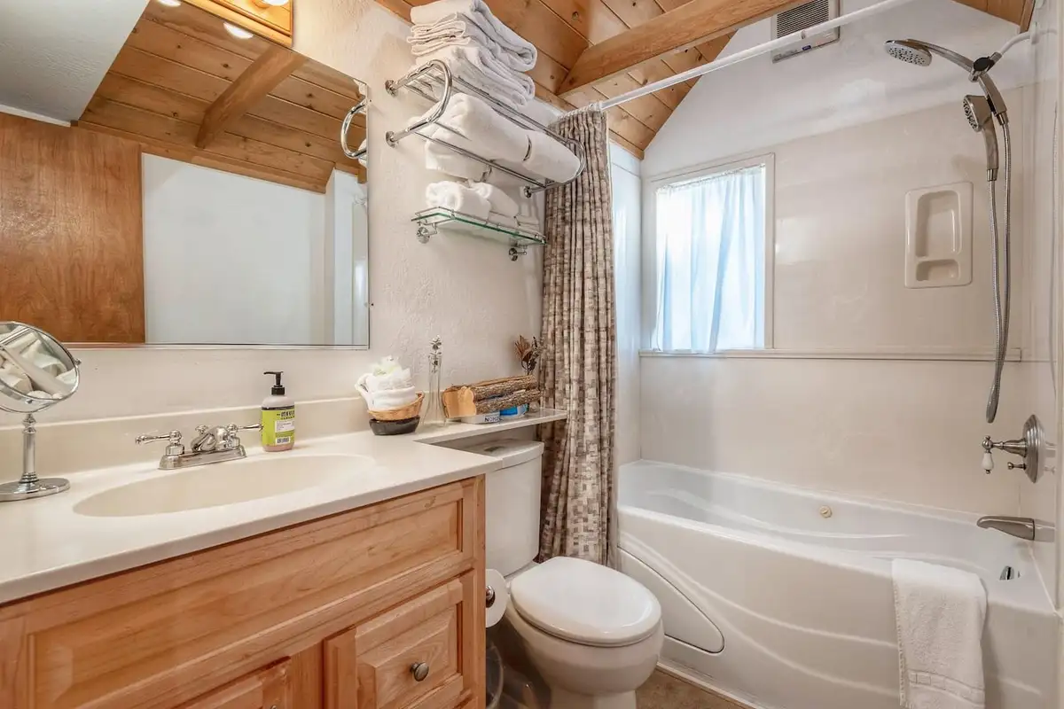 Bathroom with tub and shower and wood vanity, Lakeview Serenity Cottage