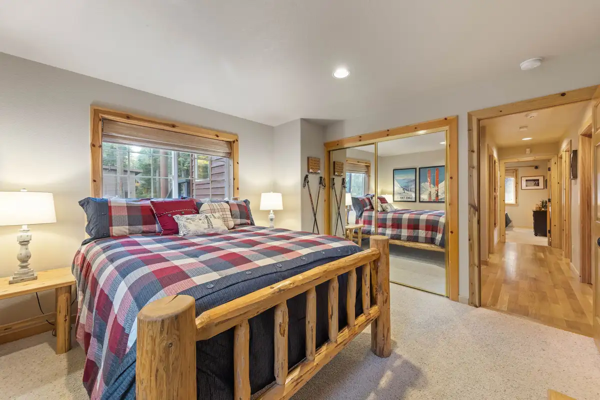 Bedroom with a log bed and plaid bedding, Lakeview Grandeur