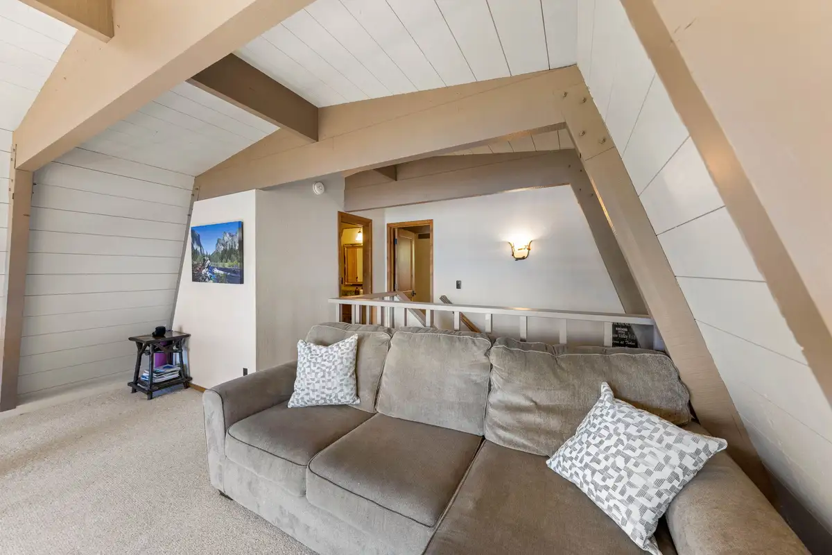 A-frame loft with a gray sofa, Livin' on the Edge
