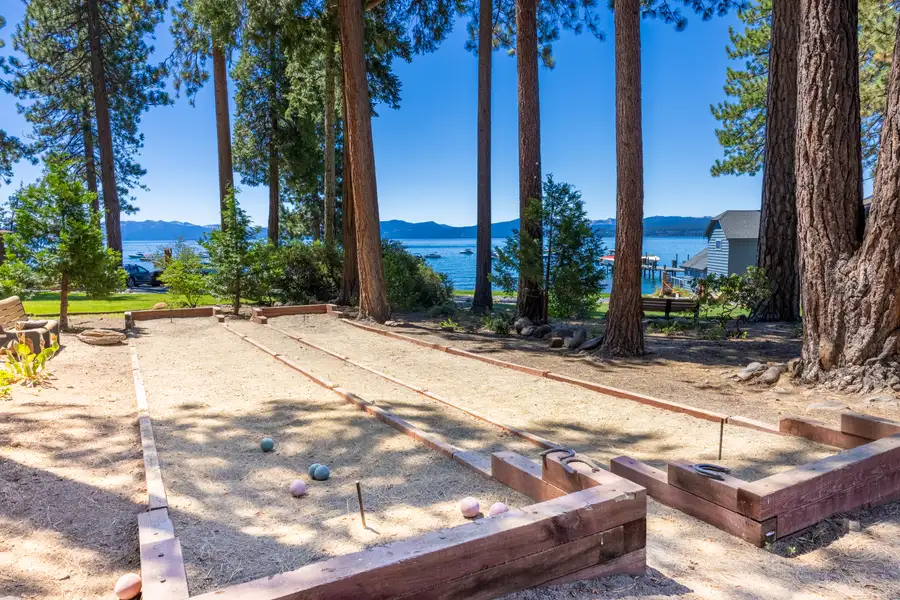 Bocce court among pines with Lake Tahoe beyond, Lakeside Luxe Retreat