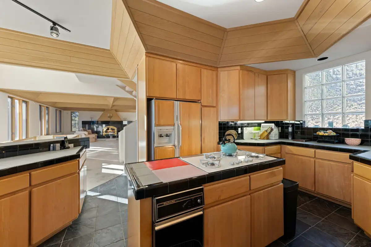 Kitchen with wood cabinets, island and wall ovens, 90s Tahoe Time Capsule