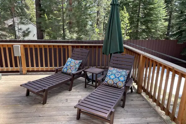Wooden deck with two lounge chairs and a patio umbrella, Restful North Ridge