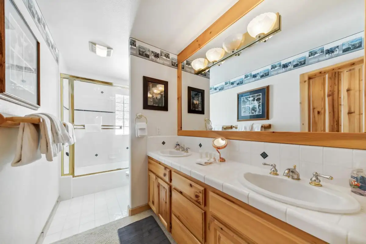 Bathroom with wood vanity and glass shower, Hastings Hideaway Cabin