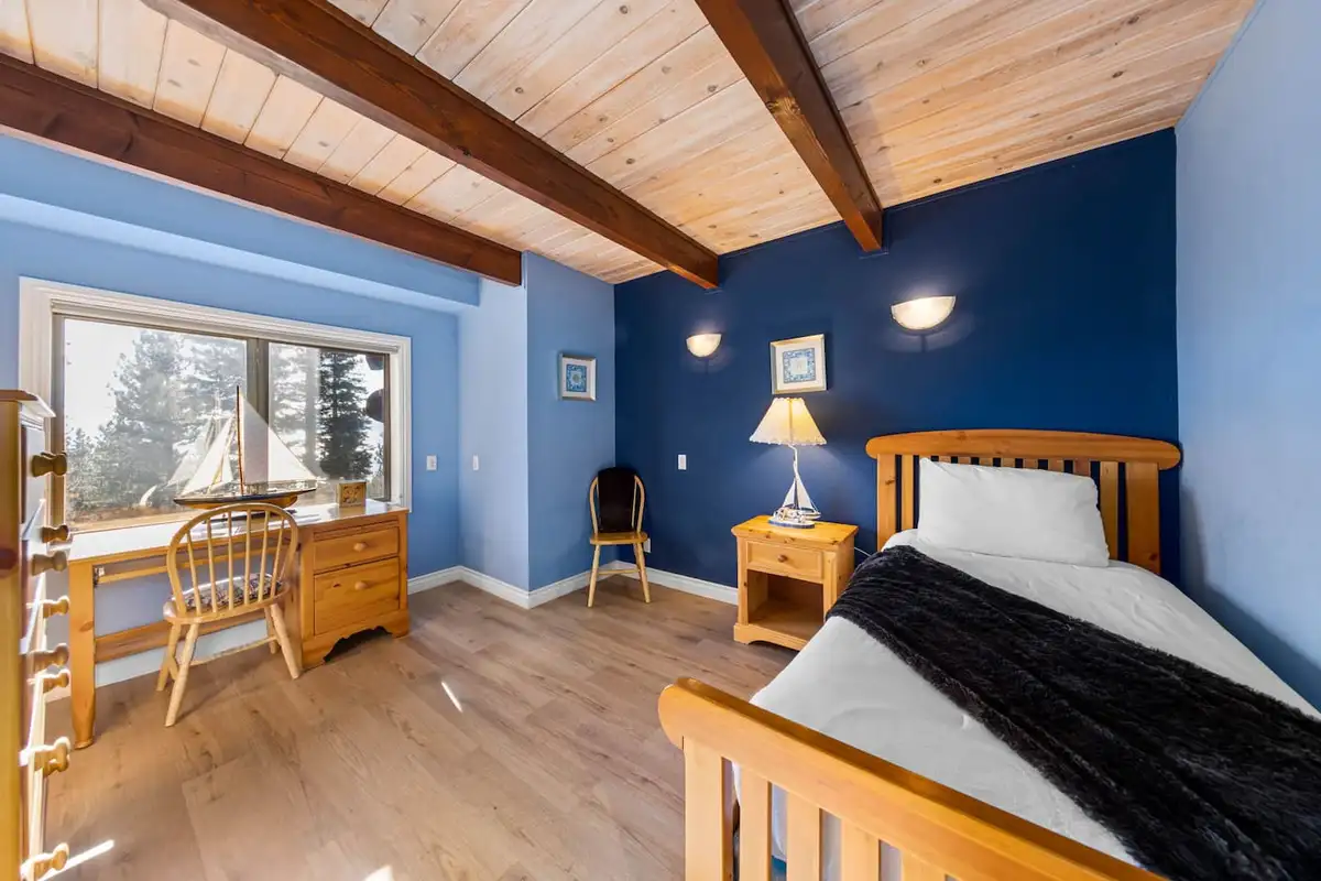 Blue bedroom with a twin bed, desk and beamed ceiling, Tranquil Alpine Bliss