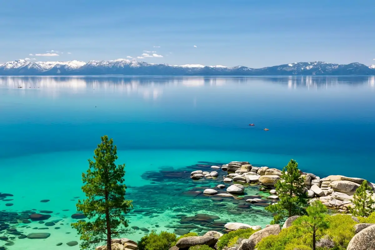 Clear turquoise lake water with granite boulders, Sunlit Incline Retreat