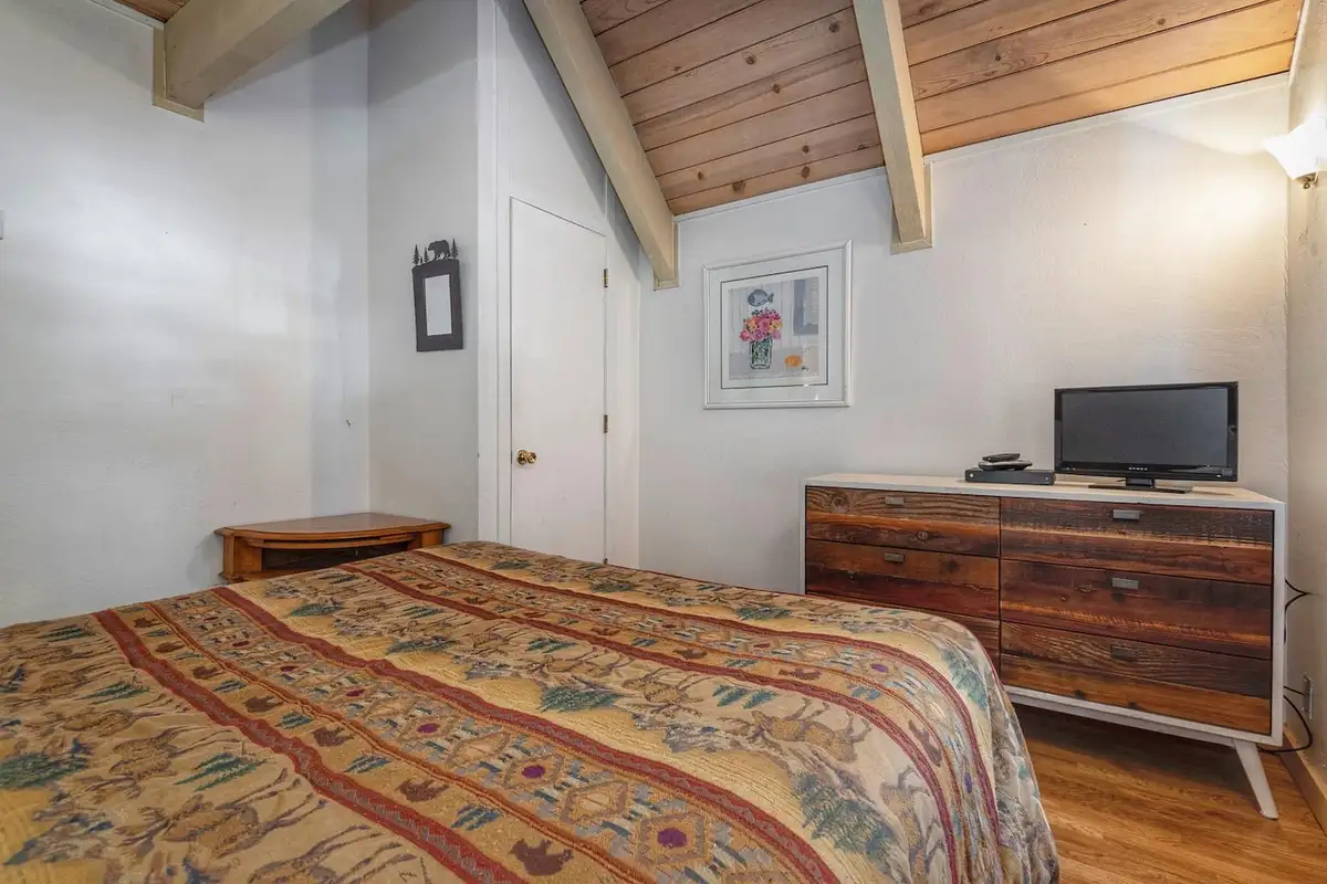 Bedroom with a dresser and small TV, Lakeview Serenity Cottage