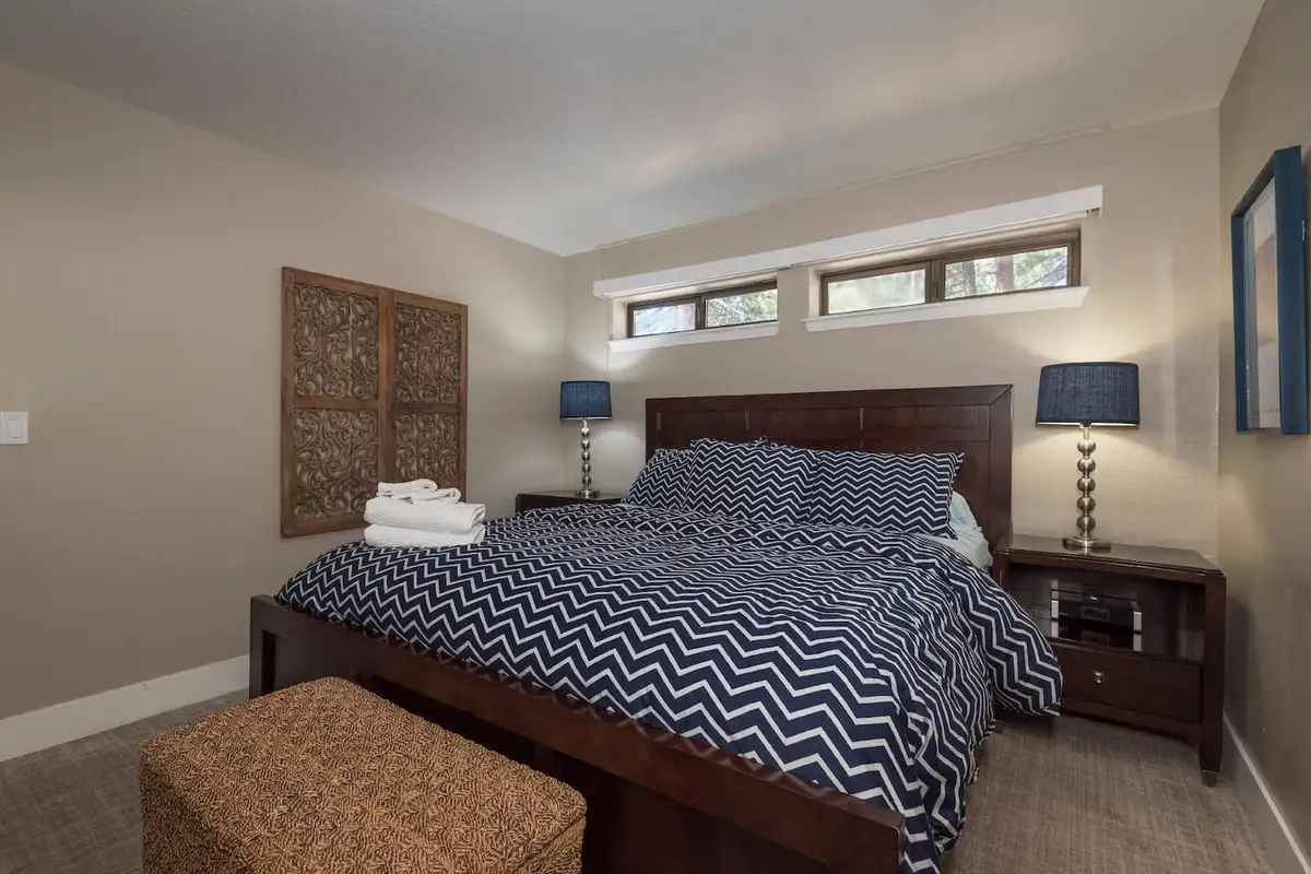 Bedroom with chevron bedding and a wicker storage bench, Skylake Serenity Retreat