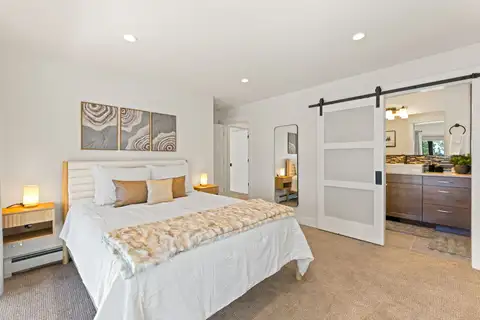 Bedroom with a bed and barn door to the bathroom, Incline Lakehouse Lookout