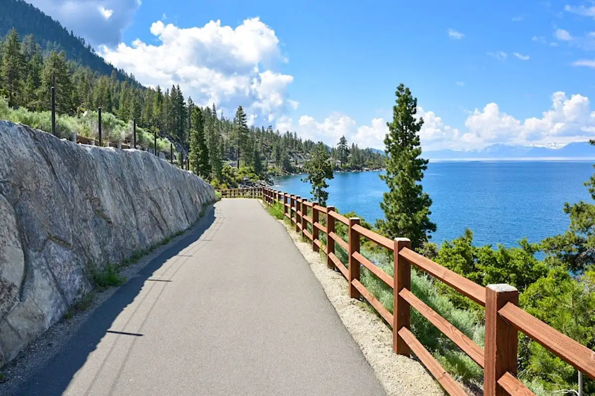 Paved lakeside trail with a wood fence, Sunlit Incline Retreat