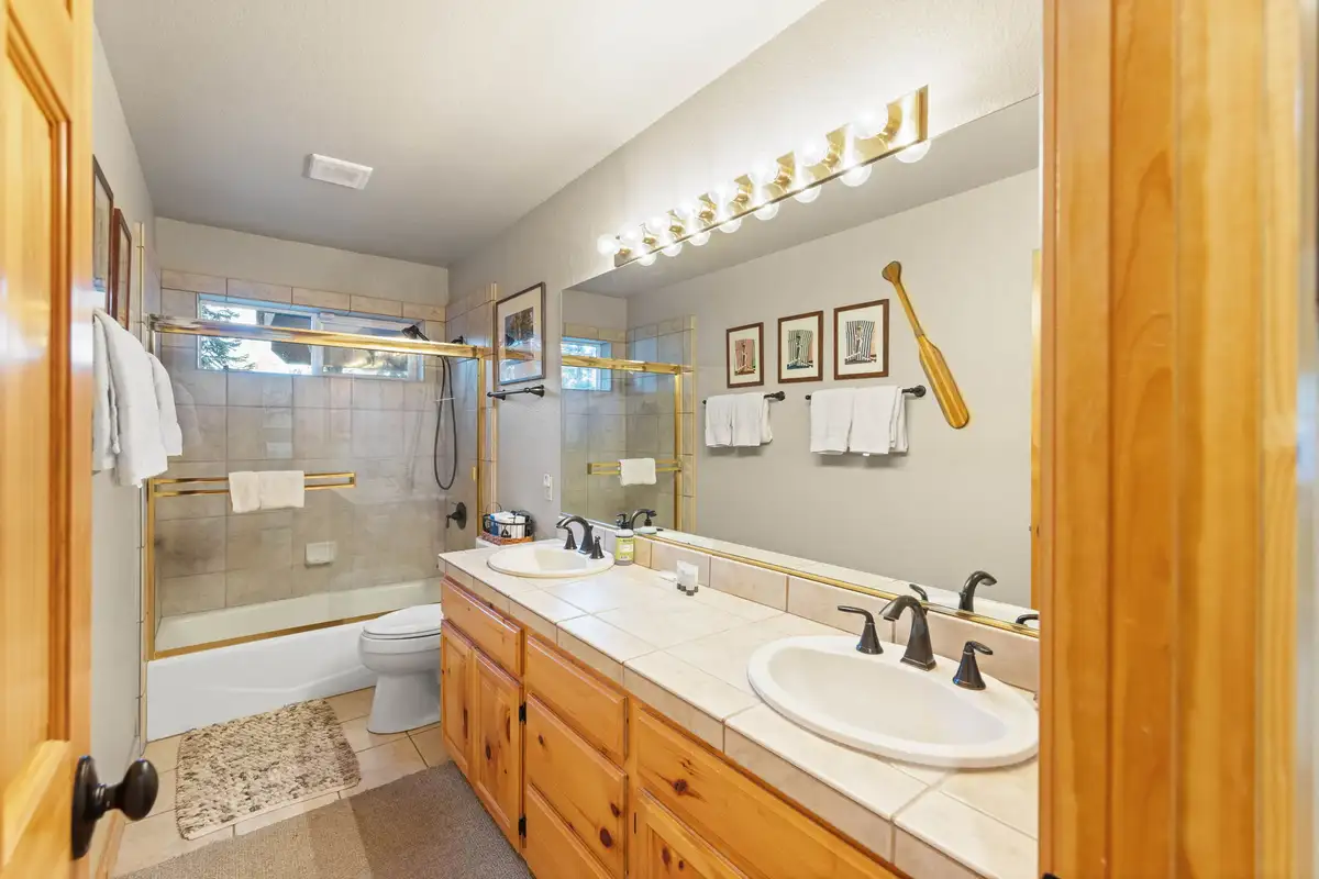Bathroom with double vanity and tub with glass doors, Lakeview Grandeur