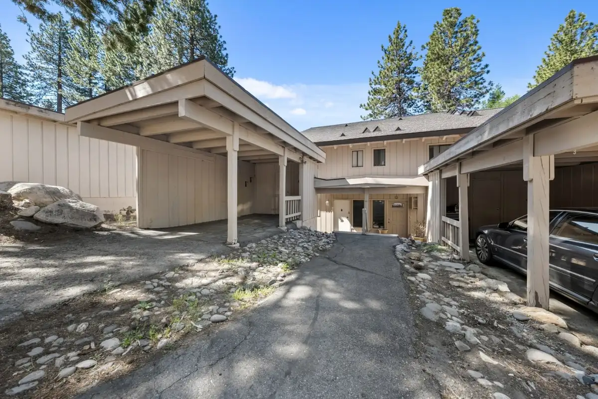 Townhome exterior with carports and pines, Skiway Suite