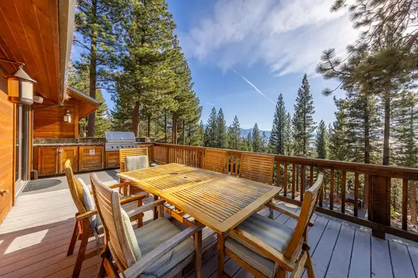 Deck with a wood dining table, grill and forest views, Tranquil Alpine Bliss