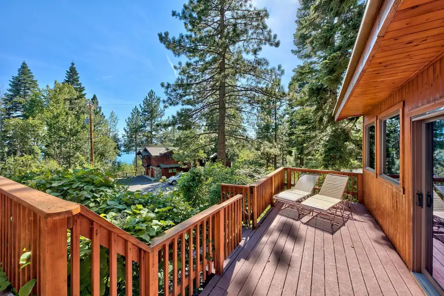 Wood deck with lounge chairs among pine trees, Mammoth Haven Retreat