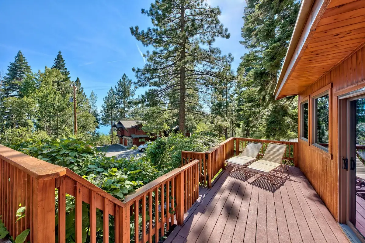 Wood deck with lounge chairs among pine trees, Mammoth Haven Retreat