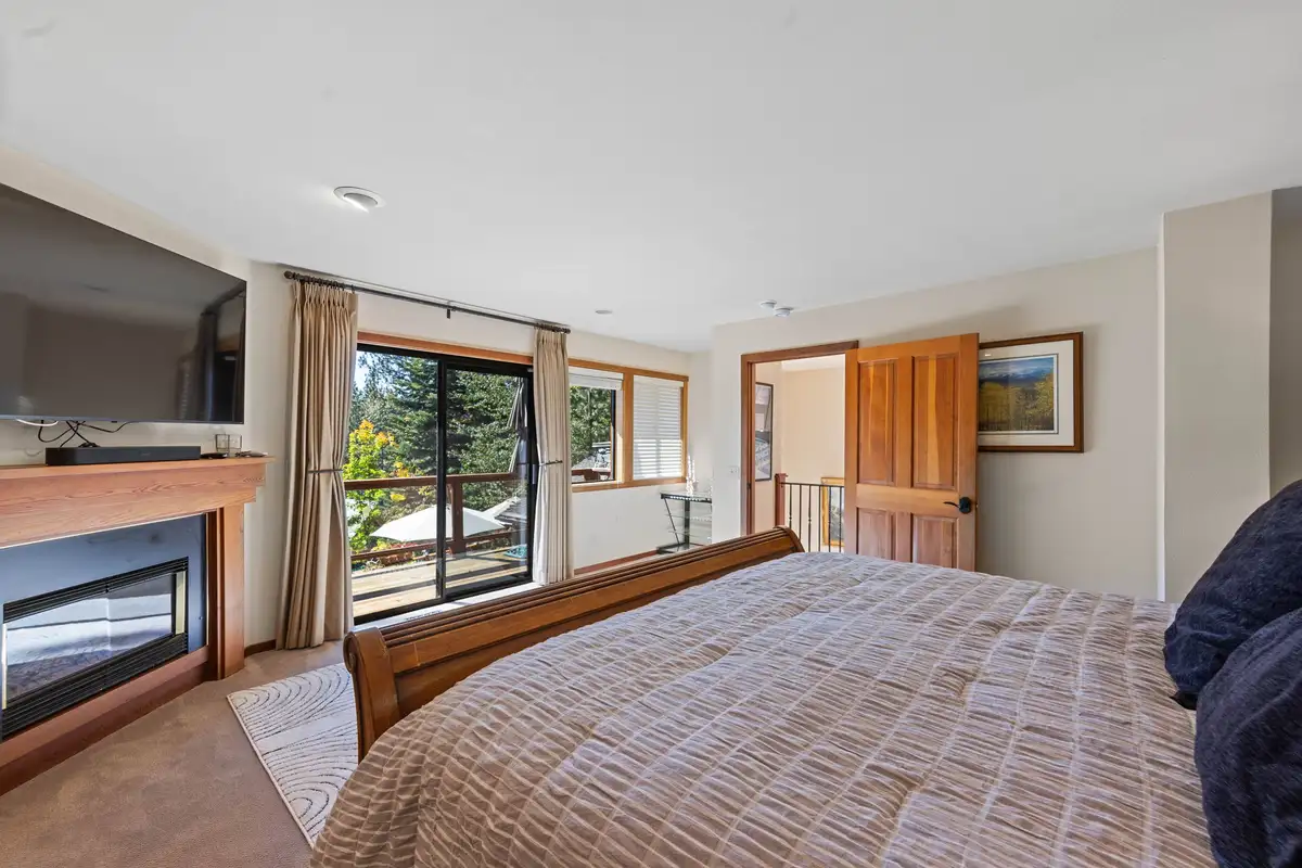 Bedroom with a bed, fireplace and sliding door, Incline Lakeside Haven
