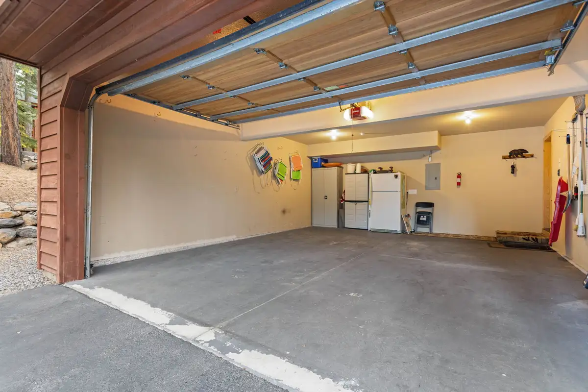 Open garage with refrigerator and storage, Lakeview Grandeur