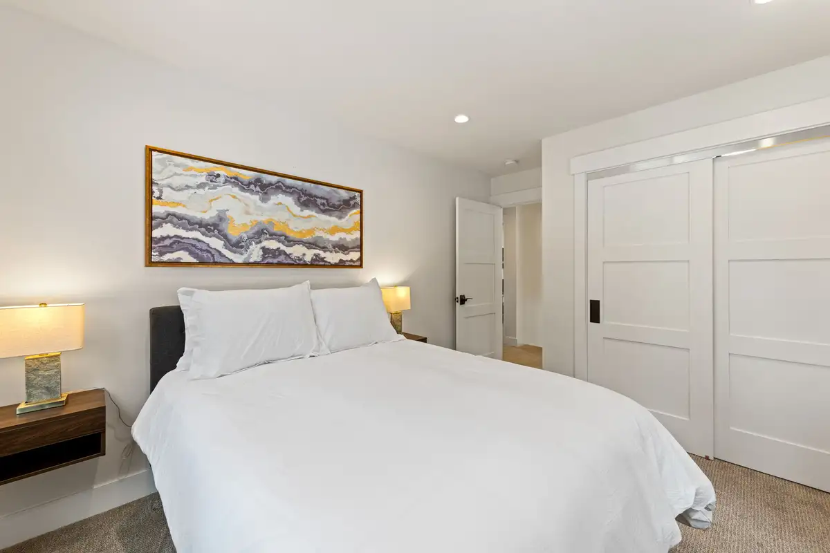 Bedroom with a bed and white sliding closet doors, Incline Lakehouse Lookout