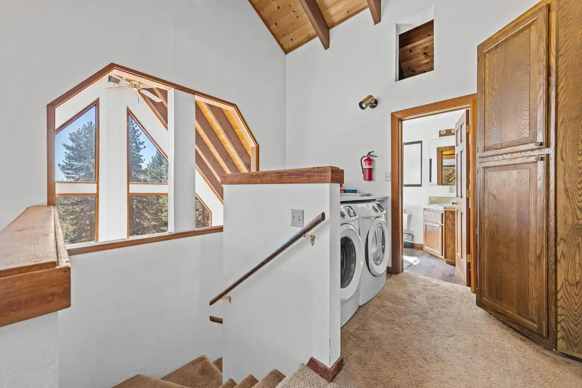 Upstairs landing with stair railing and A-frame windows, Rustic Ridge Retreat